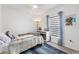 Comfortable bedroom with a ceiling fan, window, modern lamp, and stylish decor at 389 Singing Sands Cir, Lake Wales, FL 33859