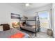 Charming bedroom features a bunk bed, soft gray carpet, and beach-themed decor at 389 Singing Sands Cir, Lake Wales, FL 33859