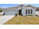 Charming single-story home with manicured lawn, rock garden and a two-car garage at 389 Singing Sands Cir, Lake Wales, FL 33859