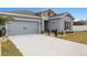 Beautiful home with a two-car garage, landscaping, and a well-maintained lawn at 389 Singing Sands Cir, Lake Wales, FL 33859