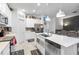 Bright kitchen offers stainless appliances, recessed lights, island and view to the living room at 389 Singing Sands Cir, Lake Wales, FL 33859