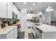 Bright kitchen features stainless steel appliances, tile backsplash and center island with sink at 389 Singing Sands Cir, Lake Wales, FL 33859
