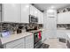 Modern kitchen featuring white cabinets, stainless steel appliances, and a stylish backsplash at 389 Singing Sands Cir, Lake Wales, FL 33859