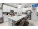 Bright kitchen features a large island, stainless steel appliances and breakfast bar seating at 389 Singing Sands Cir, Lake Wales, FL 33859