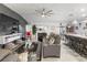 Spacious living room with ceiling fan has view of kitchen, dining and fireplace at 389 Singing Sands Cir, Lake Wales, FL 33859