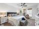 Bright main bedroom with a ceiling fan, a king bed, a bench and a treadmill at 389 Singing Sands Cir, Lake Wales, FL 33859