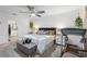 Bright main bedroom with a ceiling fan, a king bed, a bench and a treadmill at 389 Singing Sands Cir, Lake Wales, FL 33859