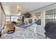 Relaxing screened-in patio with hammock, ceiling fan, and comfortable seating at 389 Singing Sands Cir, Lake Wales, FL 33859