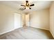 Bedroom featuring carpet, ceiling fan, and closet at 4887 Sw 159Th Lane Rd, Ocala, FL 34473
