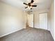 Comfortable bedroom with neutral carpeting, ceiling fan, and closet at 4887 Sw 159Th Lane Rd, Ocala, FL 34473