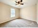 Cozy bedroom featuring neutral paint, large window, and ceiling fan at 4887 Sw 159Th Lane Rd, Ocala, FL 34473