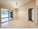 Dining room features tile floors, modern chandelier, sliding glass doors to a lanai, and access to other rooms at 4887 Sw 159Th Lane Rd, Ocala, FL 34473