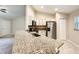 Granite breakfast bar in kitchen with stainless steel appliances, cabinetry, and an open view to living room at 4887 Sw 159Th Lane Rd, Ocala, FL 34473