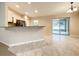 Open floor plan kitchen and dining room with tile floors and access to outdoor patio through sliding glass doors at 4887 Sw 159Th Lane Rd, Ocala, FL 34473