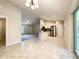 Open-concept kitchen and living room featuring modern appliances, tile flooring, and sliding glass doors at 4887 Sw 159Th Lane Rd, Ocala, FL 34473