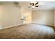Open living area featuring carpet flooring, a ceiling fan, and views of the dining area at 4887 Sw 159Th Lane Rd, Ocala, FL 34473