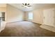 Bright living room featuring neutral carpeting and a ceiling fan for comfortable living at 4887 Sw 159Th Lane Rd, Ocala, FL 34473