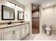 Main bathroom with double vanity, framed mirrors, and a separate shower room with brown tile at 4887 Sw 159Th Lane Rd, Ocala, FL 34473