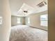 Large main bedroom featuring tray ceiling, ceiling fan, and natural light from multiple windows at 4887 Sw 159Th Lane Rd, Ocala, FL 34473