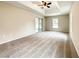 Spacious main bedroom featuring tray ceiling, ceiling fan, and sliding glass doors to porch at 4887 Sw 159Th Lane Rd, Ocala, FL 34473