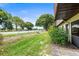 Backyard of property with lush green grass and mature trees at 940 Fenton Ln # 7, Lakeland, FL 33809