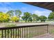 A view from the balcony featuring mature trees and a bright sunny day at 940 Fenton Ln # 7, Lakeland, FL 33809