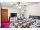 Bedroom with ceiling fan, TV, and skull patterned bedding at 940 Fenton Ln # 7, Lakeland, FL 33809
