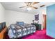 Bedroom with ceiling fan, skull patterned bedding, and access to bathroom at 940 Fenton Ln # 7, Lakeland, FL 33809