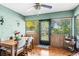 Cozy dining room featuring wood-paneled walls, natural light, and a traditional ceiling fan at 940 Fenton Ln # 7, Lakeland, FL 33809