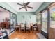 Bright sunroom-style dining area with wood flooring, beadboard accents, and sliding glass doors at 940 Fenton Ln # 7, Lakeland, FL 33809