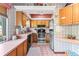 Traditional kitchen with wooden cabinets, stainless steel appliances, and pink tile flooring at 940 Fenton Ln # 7, Lakeland, FL 33809