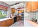 Kitchen with wooden cabinets, stainless steel oven, laminate countertops, and pink tiled floor at 940 Fenton Ln # 7, Lakeland, FL 33809
