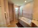 Well-lit bathroom with corner shower and separate tub at 7055 Heatherbrook Dr, Lakeland, FL 33809