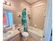 Bathroom featuring tub, shower, toilet, vanity and sink with light wood cabinets at 7055 Heatherbrook Dr, Lakeland, FL 33809