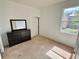Bright bedroom with a window providing natural light and a dark wood dresser at 7055 Heatherbrook Dr, Lakeland, FL 33809