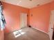 An empty bedroom with peach walls and carpet at 7055 Heatherbrook Dr, Lakeland, FL 33809