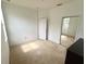 Simple bedroom featuring neutral carpet, white walls, and a mirrored closet at 7055 Heatherbrook Dr, Lakeland, FL 33809