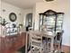 Charming dining room featuring hardwood floors, a display cabinet, and stylish decor at 7055 Heatherbrook Dr, Lakeland, FL 33809