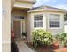 Inviting front entrance with decorative plants, a chair, and updated windows at 7055 Heatherbrook Dr, Lakeland, FL 33809