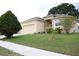 Single-Gathering home exterior with lush green lawn, mature trees, and side-entry three-car garage at 7055 Heatherbrook Dr, Lakeland, FL 33809
