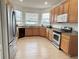 Bright kitchen with stainless steel appliances, wooden cabinets, and granite countertops at 7055 Heatherbrook Dr, Lakeland, FL 33809