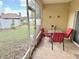 This screened patio features a table with four red chairs, offering an ideal space for outdoor relaxation and dining at 7055 Heatherbrook Dr, Lakeland, FL 33809