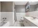 Clean bathroom with white tile, gray accents, shower and a single sink vanity at 3120 S Polk Ave, Lakeland, FL 33803