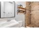 Bathroom featuring a shower with tiled walls, modern vanity, and a decorative shelf at 3120 S Polk Ave, Lakeland, FL 33803