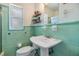 Vintage tiled bathroom featuring mint green tile and a pedestal sink at 3120 S Polk Ave, Lakeland, FL 33803