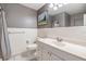 Clean bathroom with gray walls, white tile accents, shower and a single sink vanity at 3120 S Polk Ave, Lakeland, FL 33803