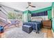 Comfortable bedroom with textured wallpaper, fan, tiled floor and natural lighting at 3120 S Polk Ave, Lakeland, FL 33803