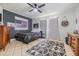 Comfortable bedroom featuring tiled floor, fan, dresser and bright natural lighting at 3120 S Polk Ave, Lakeland, FL 33803
