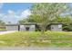Charming single-story home with a well-maintained lawn and mature trees creating a welcoming curb appeal at 3120 S Polk Ave, Lakeland, FL 33803