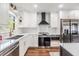 Bright kitchen with white cabinets, quartz countertops, stainless steel appliances, and herringbone tile backsplash at 3120 S Polk Ave, Lakeland, FL 33803